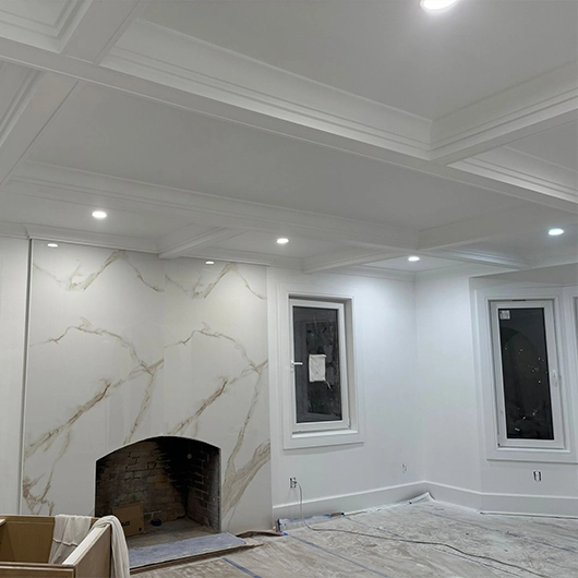 Professional painter preparing interior walls before painting in Amityville, NY